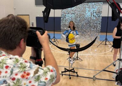 Tom Uchida photographing cheerleaders at Lawson High School